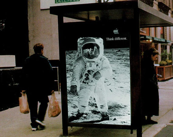 Photograph of the Apple 'Think Different' campaign. Black and white photograph of Buzz Aldrin, displayed in a bus shelter.