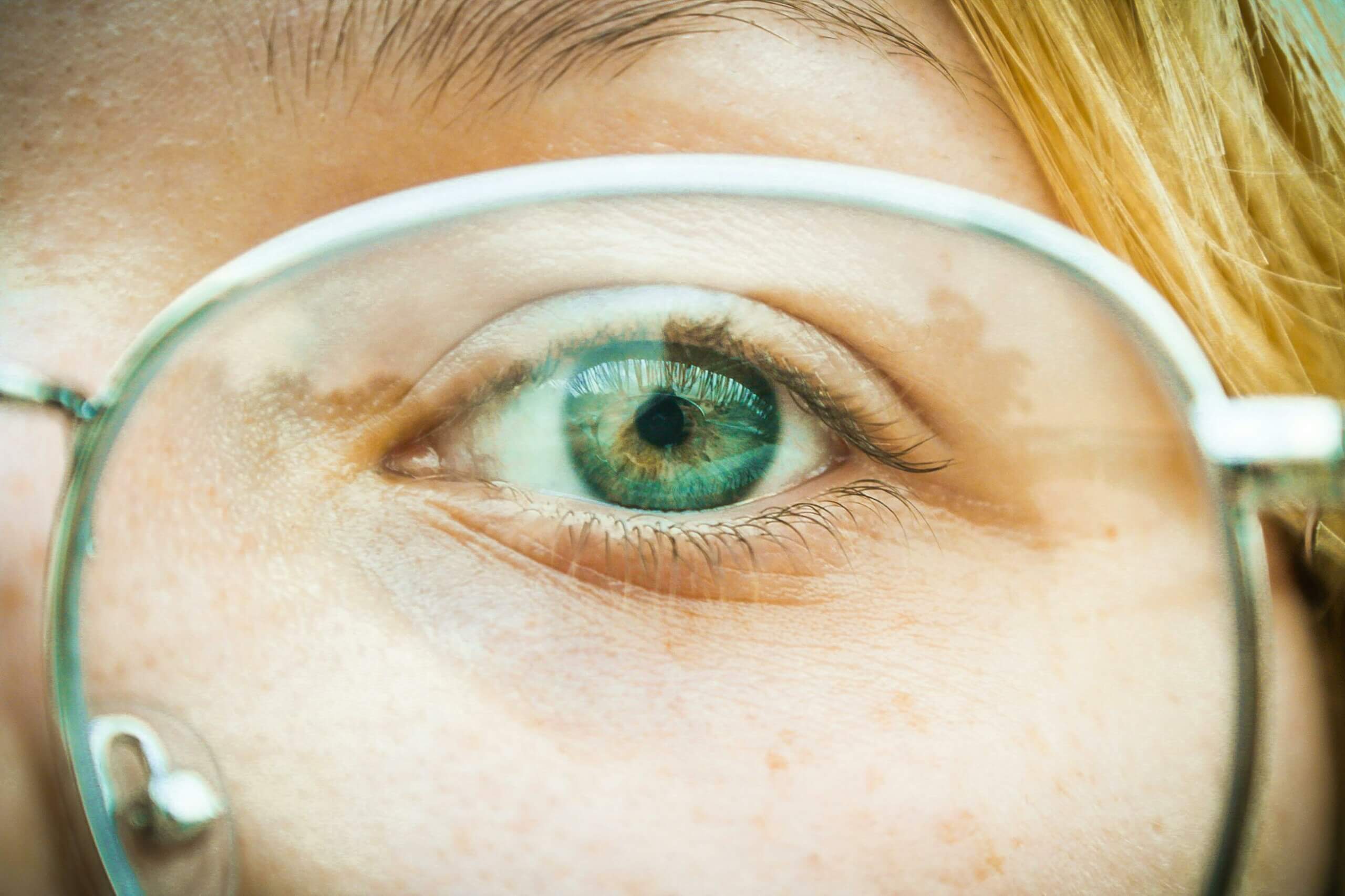 Close up of a person's eye, looking to camera through glasses. For app success, focus on understanding your users.