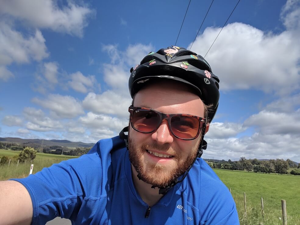 Wave Digital Senior App Developer Matthew Martin cycling on a sunny day.